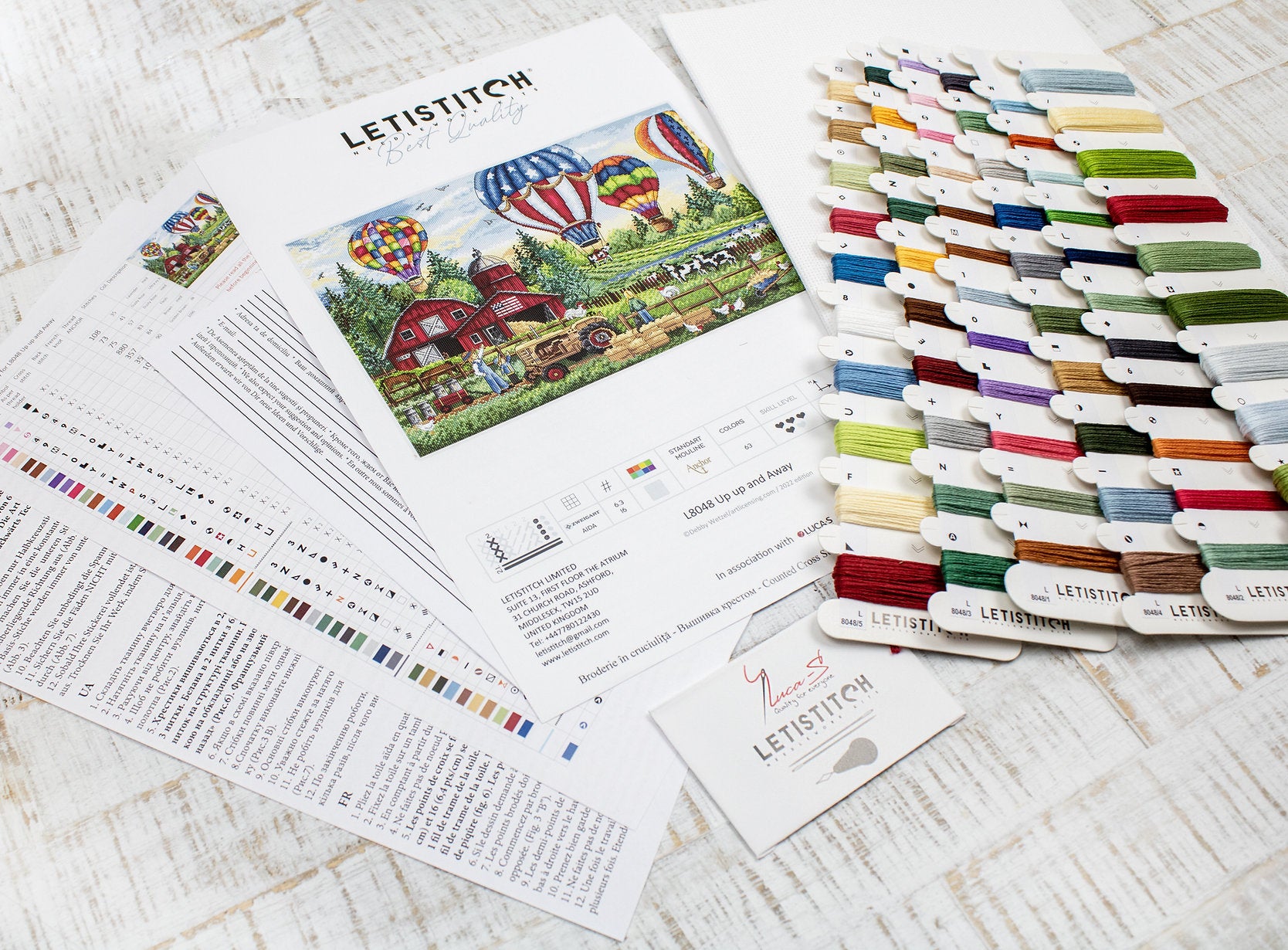 Up Up and Away L8048 Counted Cross Stitch Kit featuring colorful threads, Aida canvas, and detailed instruction chart.